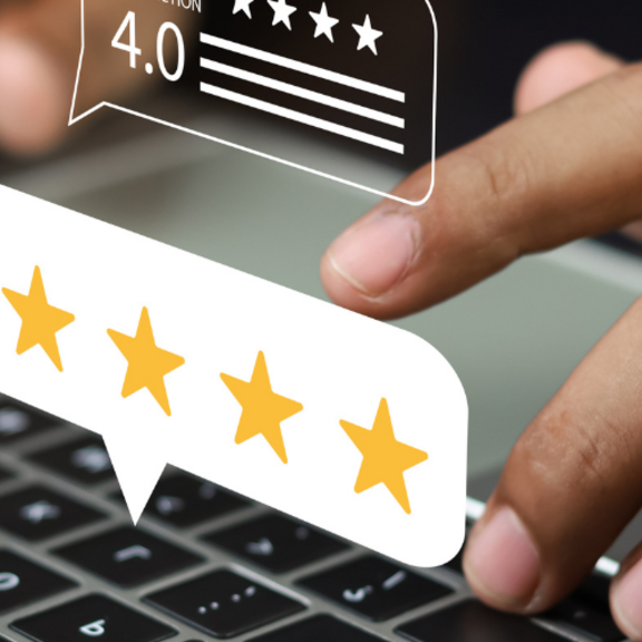 Image of person typing on laptop with star rating visualisation