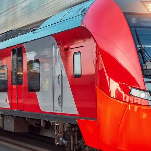 Red train travelling through station at high speed