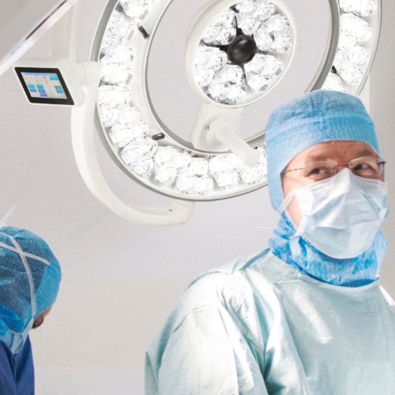 Image of surgeon and clinical team in scrubs performing surgery in operating room