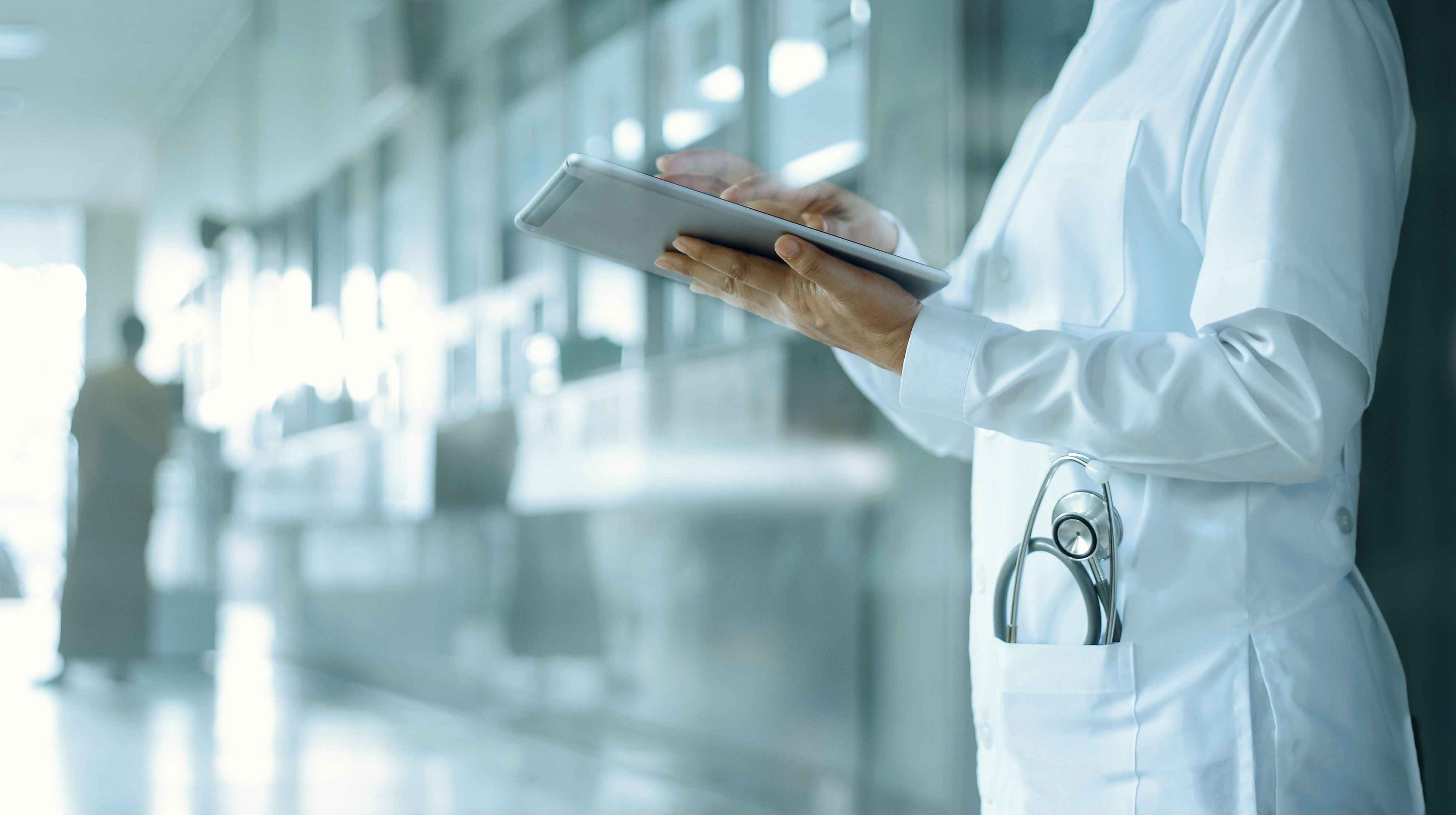 Surgeon in busy corridor with patients 