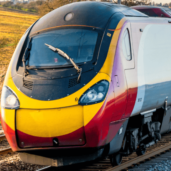Image of a fast moving train moving quickly along the tracks