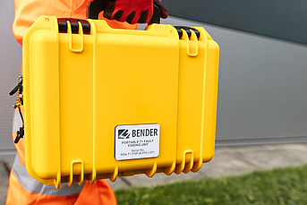 An engineer carrying a portable Tier 1 case 