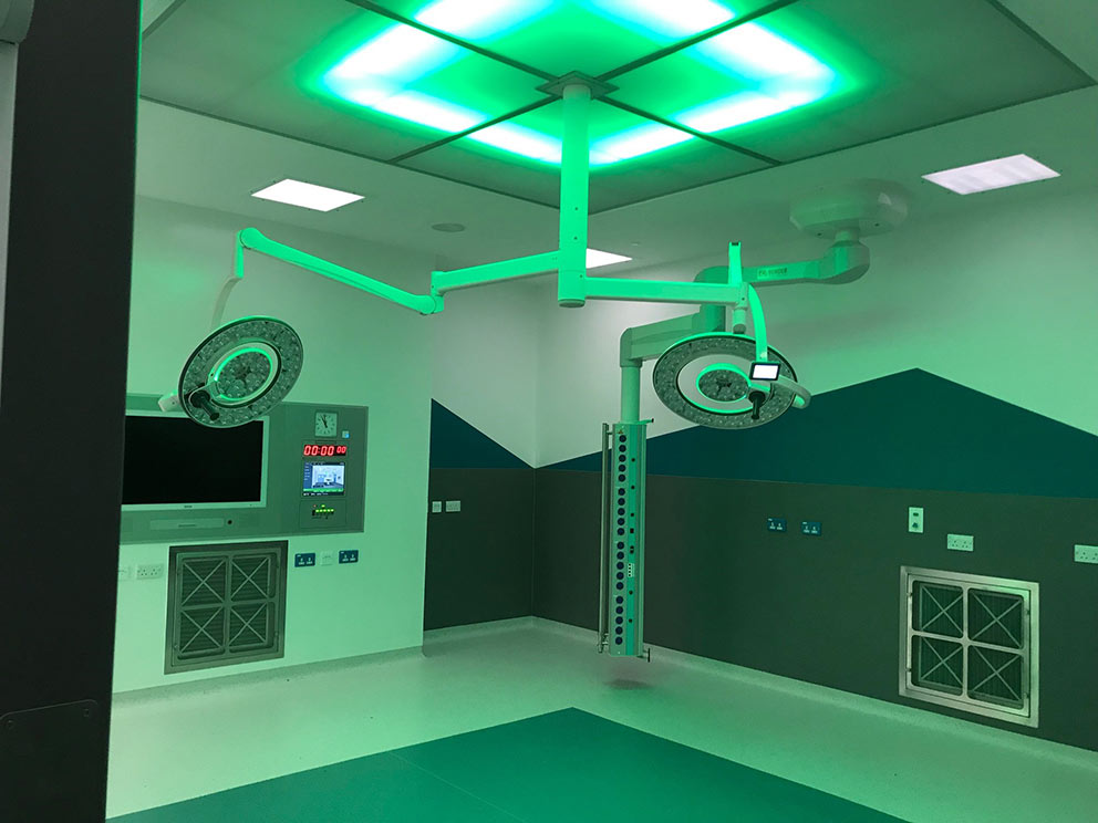 A major operating theatre upgrade at Westmorland General Hospital in Kendal, Cumbria has been completed with advanced equipment supplied, installed and commissioned by Bender UK, including LED operating lights, touchscreen theatre control panels with inte A major operating theatre upgrade at Westmorland General Hospital in Kendal, Cumbria has been completed with advanced equipment supplied, installed and commissioned by Bender UK, including LED operating lights, touchscreen theatre control panels with integrated PACS 4K viewing screen, and Contempo clinical pendants. The refurbished theatre benefits from new medical IT power systems and uninterruptible power supplies (UPS) to provide ultra-safe and resilient power for the Group 2 critical care area, which were also provided by Bender UK. The power provision includes Bender’s unique ATICS changeover solution purpose designed for medical applications with patient safety at the very core of its development. The ATICS design incorporates permanent self-testing across all critical components and is the only medical auto-changeover device independently certified as fully compliant with Safety Integrity Level (SIL) 2 parts 1-3. The operating lights are part of the award-winning Q-Flow™ range from Merivaara that Bender UK exclusively distribute in the UK and the Republic of Ireland. The lights deliver best-in-class colour rendering that is vital for surgeons and theatre staff to monitor the health and well-being of patients during operations, and a hugely efficient column of daylight-quality light to illuminate deep cavities. Theatre 2 at Westmorland General is for orthopaedic surgery and the refurbishment included a clean air canopy. The circular design of the Q-Flow™ lights optimises laminar air flow to take contaminated air away from the operating site, reducing the potential for patient infections. Bender UK’s theatre control panels are manufactured in-house to exact customer specifications, with every panel programmed and configured to the client’s specific needs. Control of the theatre environment is combined into a single ergonomic fingertip-operated interface panel for lighting, temperature and humidity, ventilation and critical alarms. Each panel incorporates a unique antimicrobial finish that minimises the risk of contamination and the spread of harmful bacteria and aids hospitals in infection prevention and control. The unit in Theatre 2 is integrated with a 42-inch PACS 4K screen for viewing scans and x-rays, and the system also includes Bluetooth-enabled speakers. Sam Parry, Clinical Sales Manager - North at Bender UK explained that the company has previously worked with the Trust on the refurbishment of operating theatres at Furness General Hospital and with equipping new theatres within the South Lakes Birth Centre. He said: “The Trust was particularly impressed with the touch screen control panels and is seeking to standardise the equipment across the theatres. They also had experience with the Merivaara Q-Flow™ LED operating lights that have proved a popular choice since their introduction into the UK with more than 100 sets already installed.” Bender UK is also contracted to provide maintenance and service support to the Trust for clinical equipment and critical care power, offering round the clock maintenance, verification, repair and rapid response call-out services. Refurbishment of Theatre 2 was carried out as part of a £19 million programme to transform and improve the environment and facilities for patients using the Trust. Westmorland General Hospital in Kendal is one of three hospitals within the University Hospitals of Morecambe Bay NHS Foundation Trust; the others are Furness General Hospital in Barrow, and the Royal Lancaster Infirmary. The Trust provides community and hospital services across the Morecambe Bay area. Westmorland General Hospital is the Trust headquarters and provides a range of general hospital services including elective operations, outpatient appointments and midwifery-led maternity services, together with an Urgent Treatment Centre. For more information on the full range of Bender UK services to private and NHS hospitals and clinics visit our solutions section.