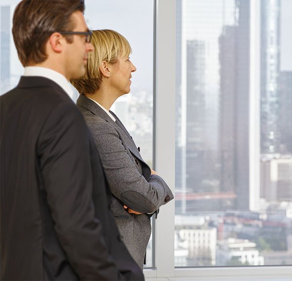 Senior leadership stood looking out of the window.