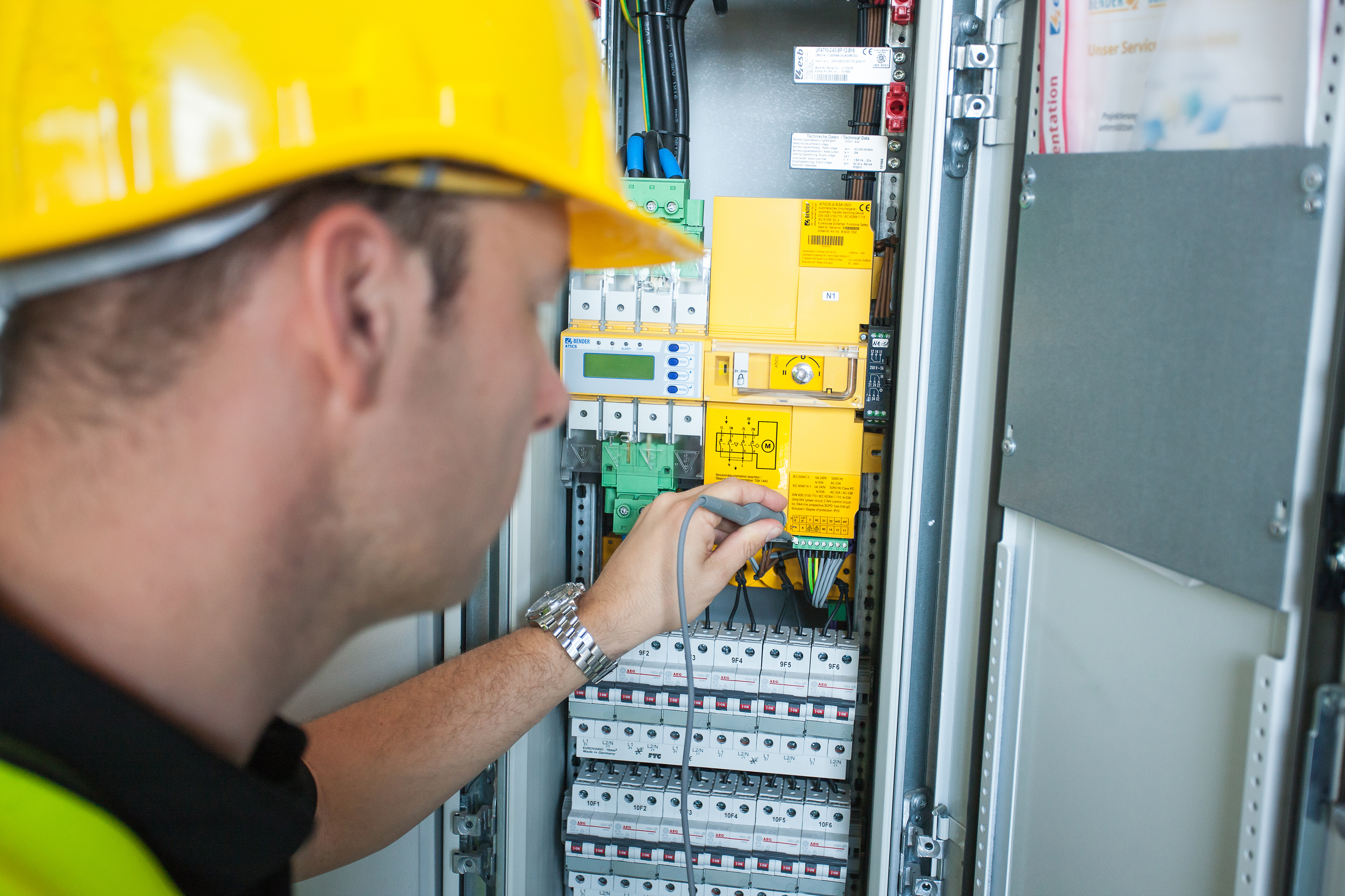 Engineer wearing personal protective equipment testing ATICs changeover in medical IT system.