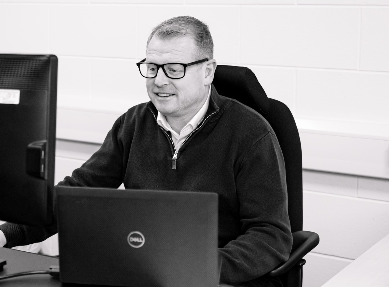 Image of the managing director at Bender UK in front of a computer screen