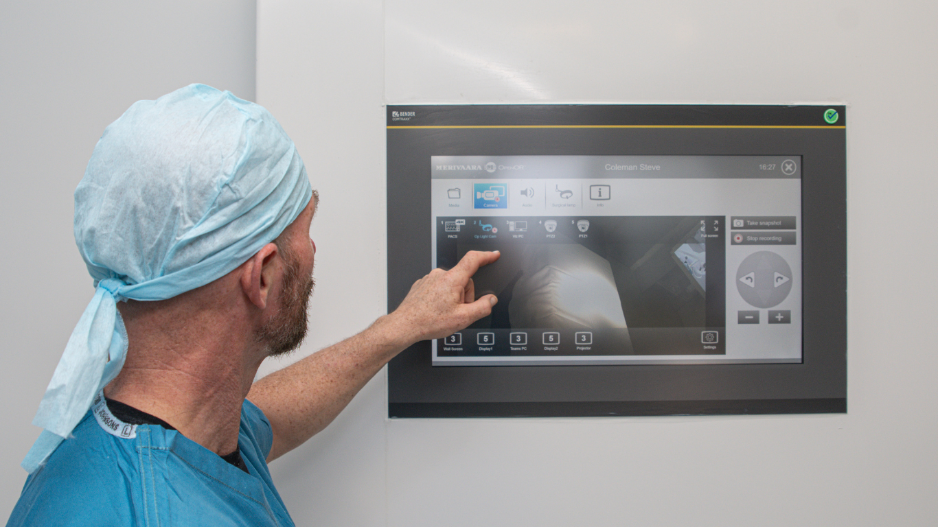 Surgeon using operating theatre control panel