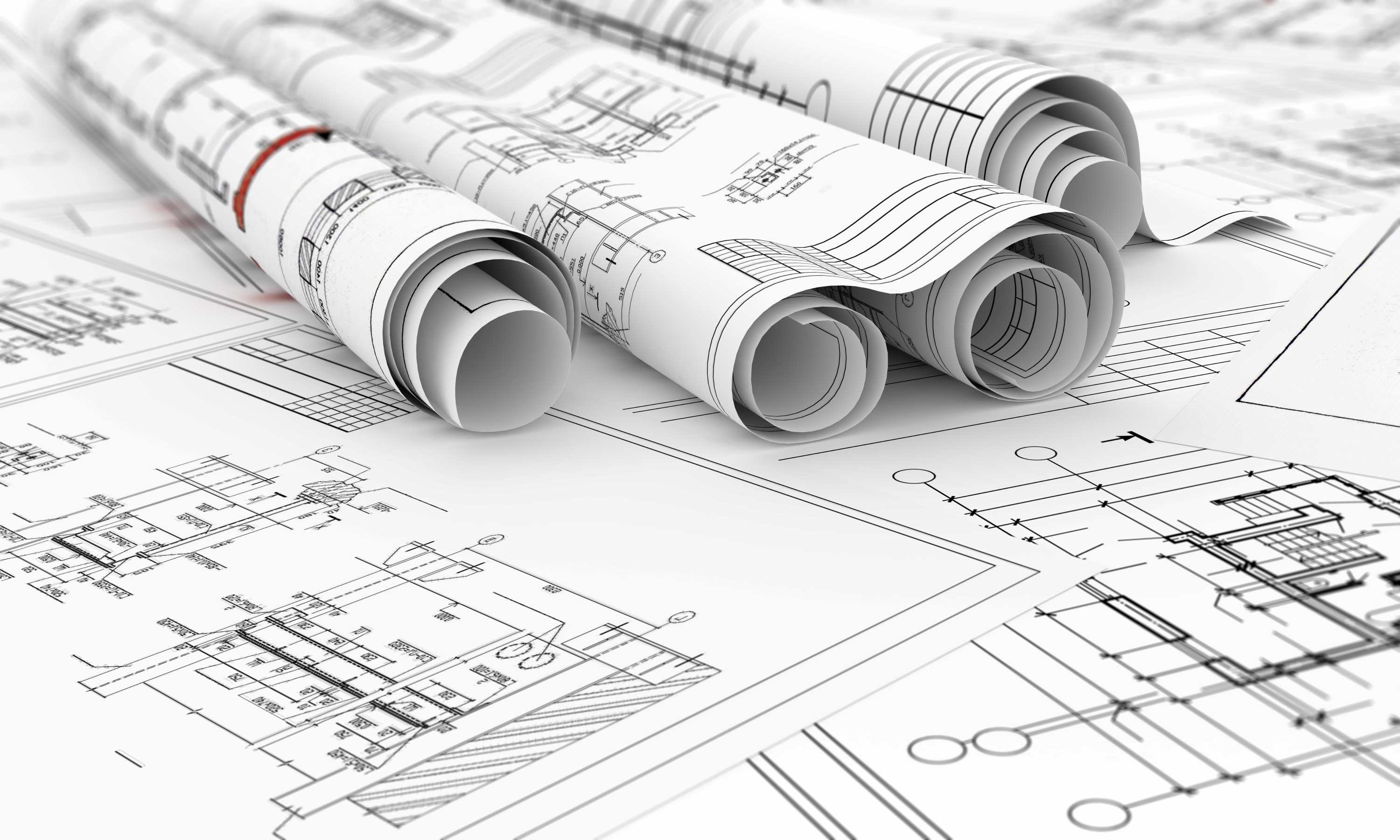Image of various drawings for a build project on a table