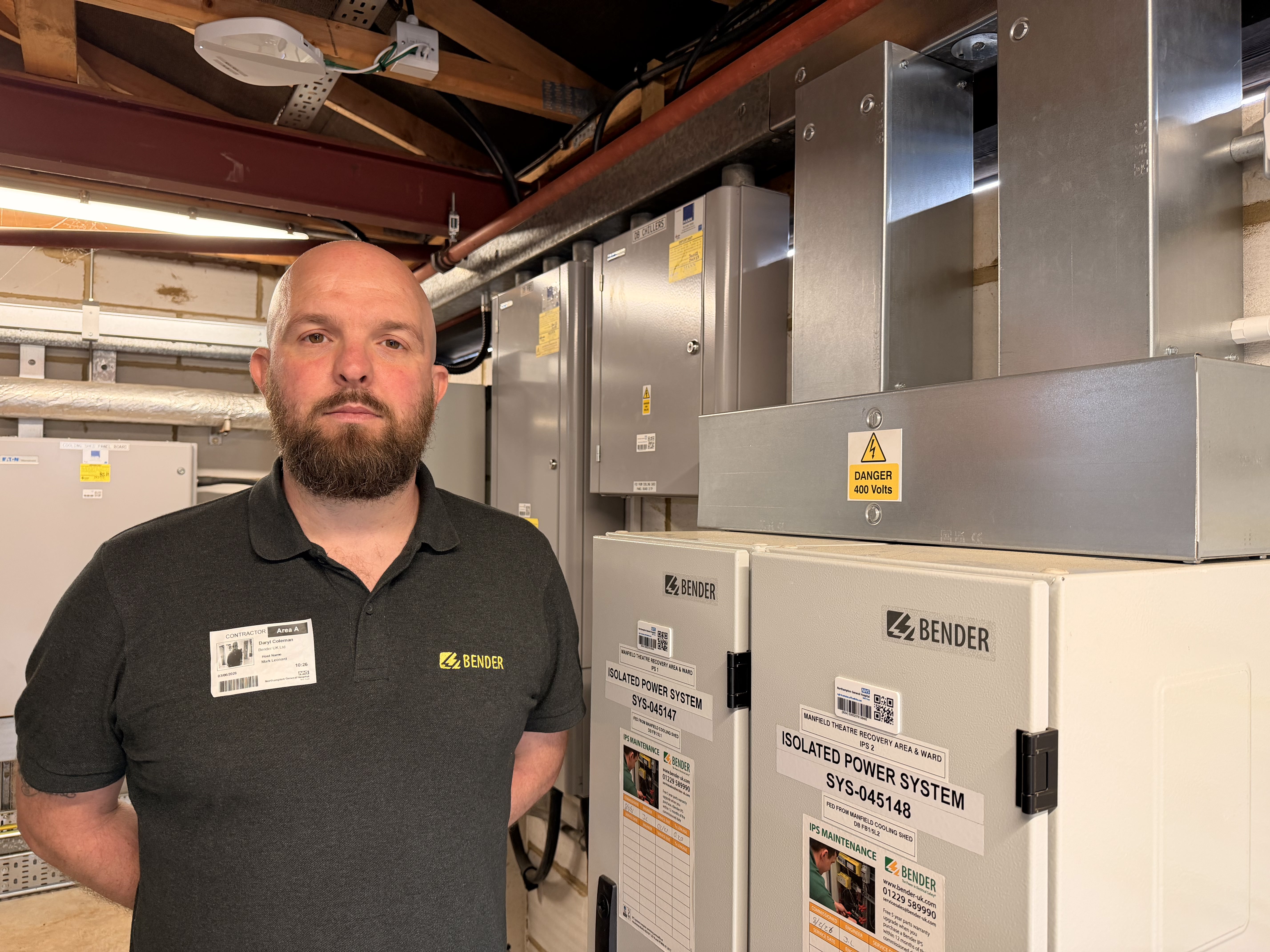 Daryl Coleman, Bender UK Engineer stood next to new Medical IT System 