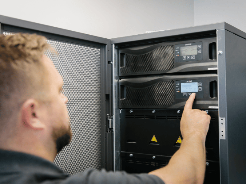 An image of an engineer maintaining a UPS